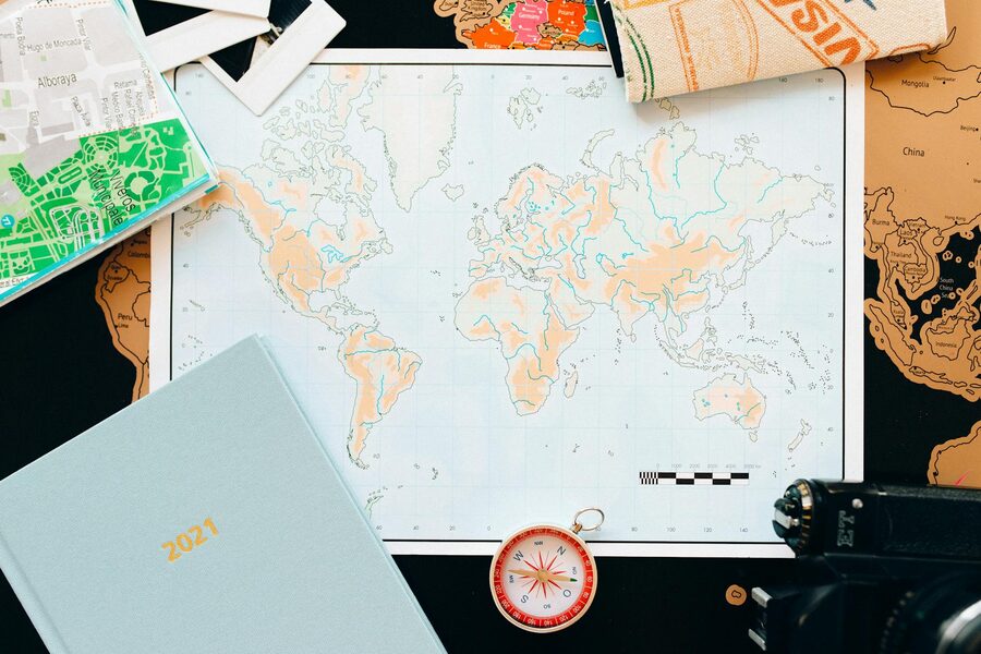 A travel planner with maps and compass